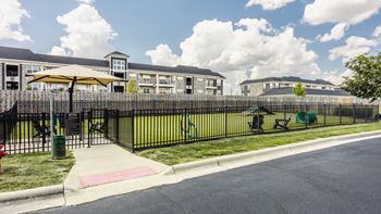 A sunny day at a residential area with apartment buildings and a playground.
